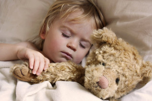 cute young baby toddler asleep with teddy bear