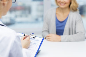 close up of doctor and woman meeting at hospital