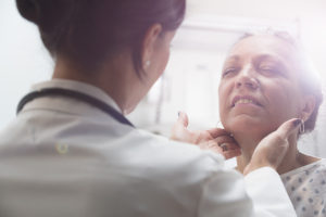 Hispanic doctor examining older patient