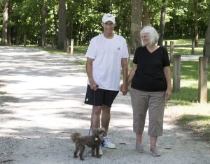 After suffering from a heart attack on the tennis court in July 2017, Steven Huntley enjoys taking walks with his wife, Linda, and dog, Coco, to help him stay healthy.