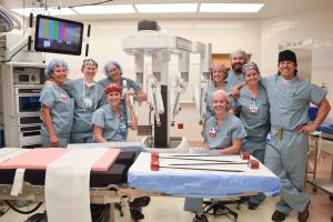 Riverview Health general surgeon George Negrete, MD, (front right) and the surgical team pose with the da Vinci Xi surgical system. The robot was purchased in 2021 and allows surgeons to perform procedures through just a few small incisions.